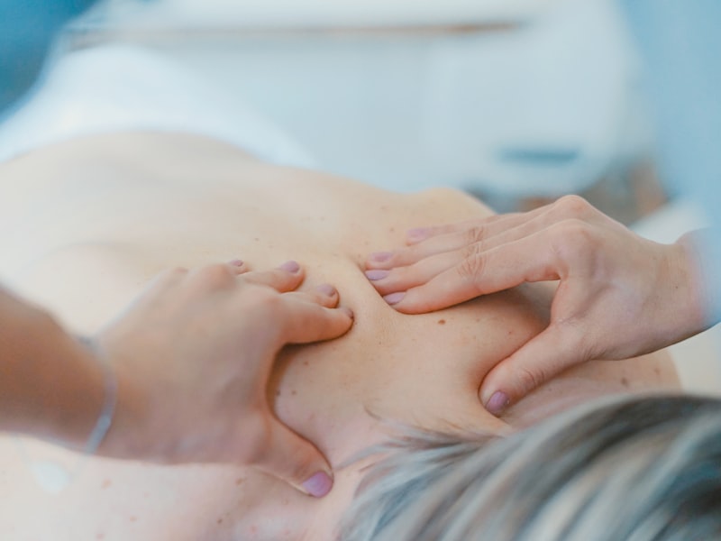 Therapist assessing a patient's back and posture