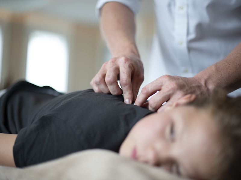 Practitioner performing a gentle spinal adjustment